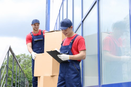 Professional movers handling office equipment